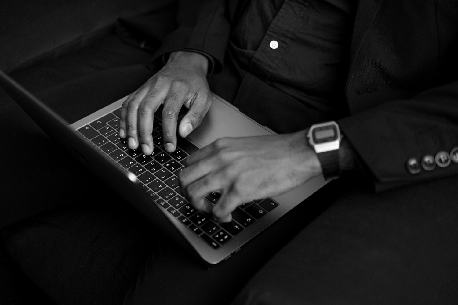 Man Typing on Laptop